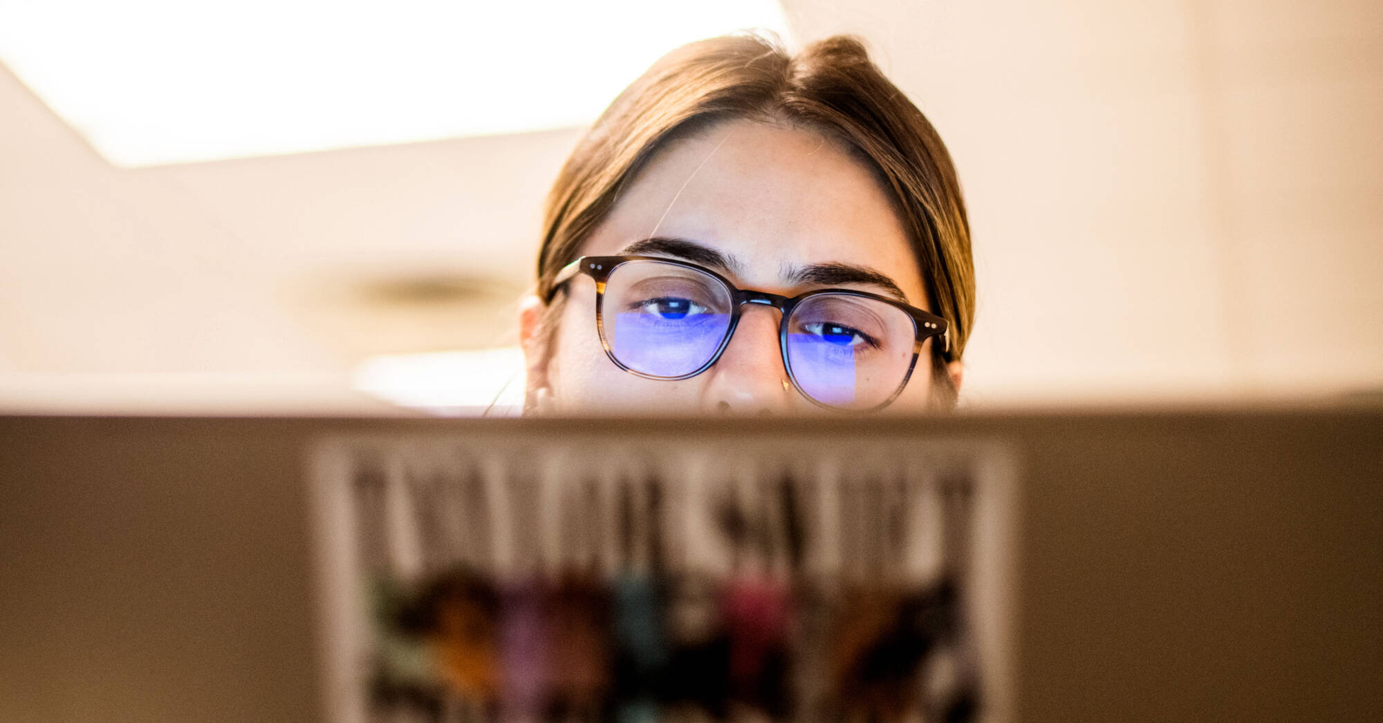 Natalie Aguirre works on her laptop during class. Aguirre’s professor, Alisha Karabinus, assistant professor of writing, uses AI tools in her writing and digital studies classes.
